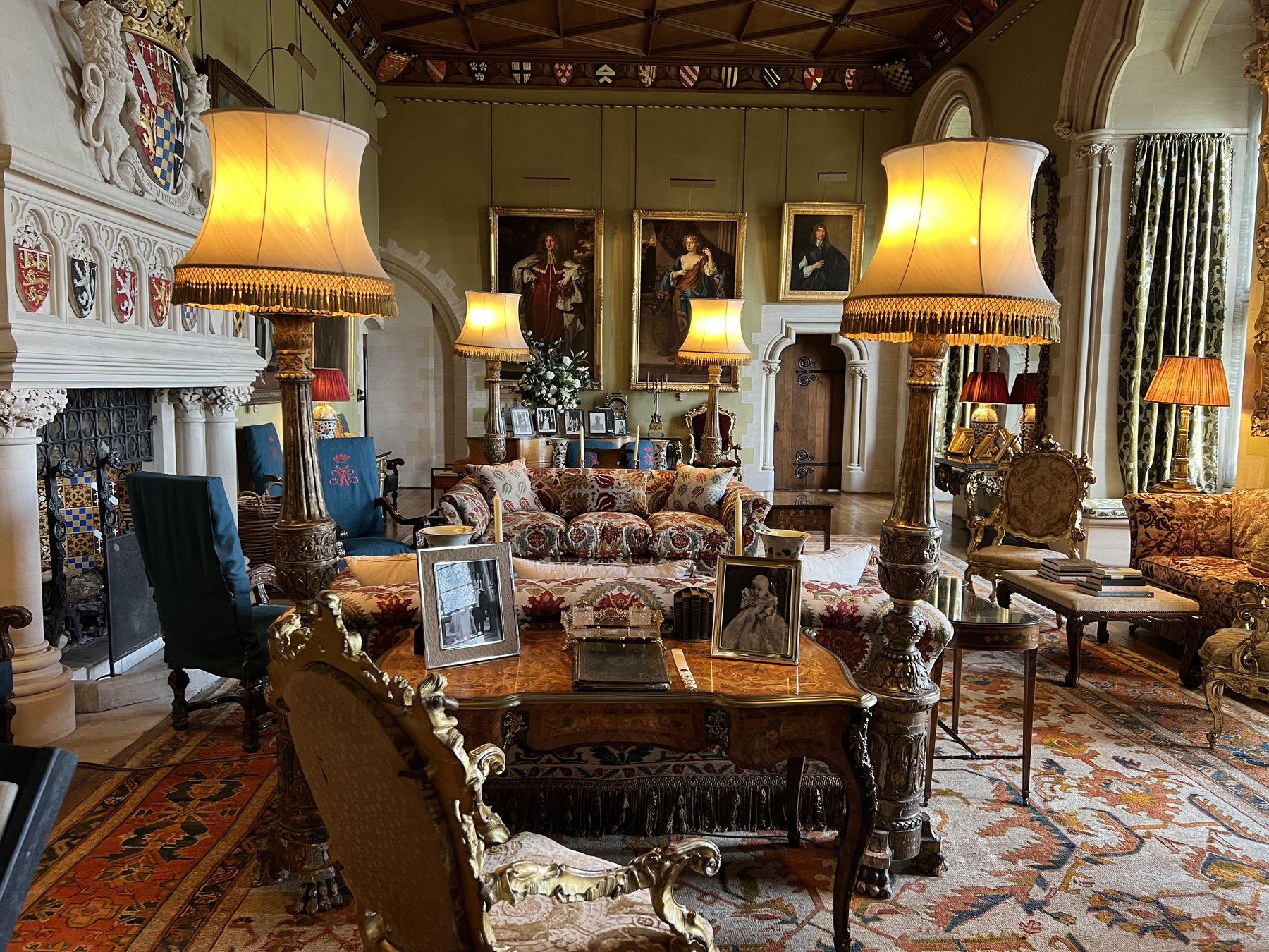 Grand drawing room lit by restored table lamps with fringed shades
