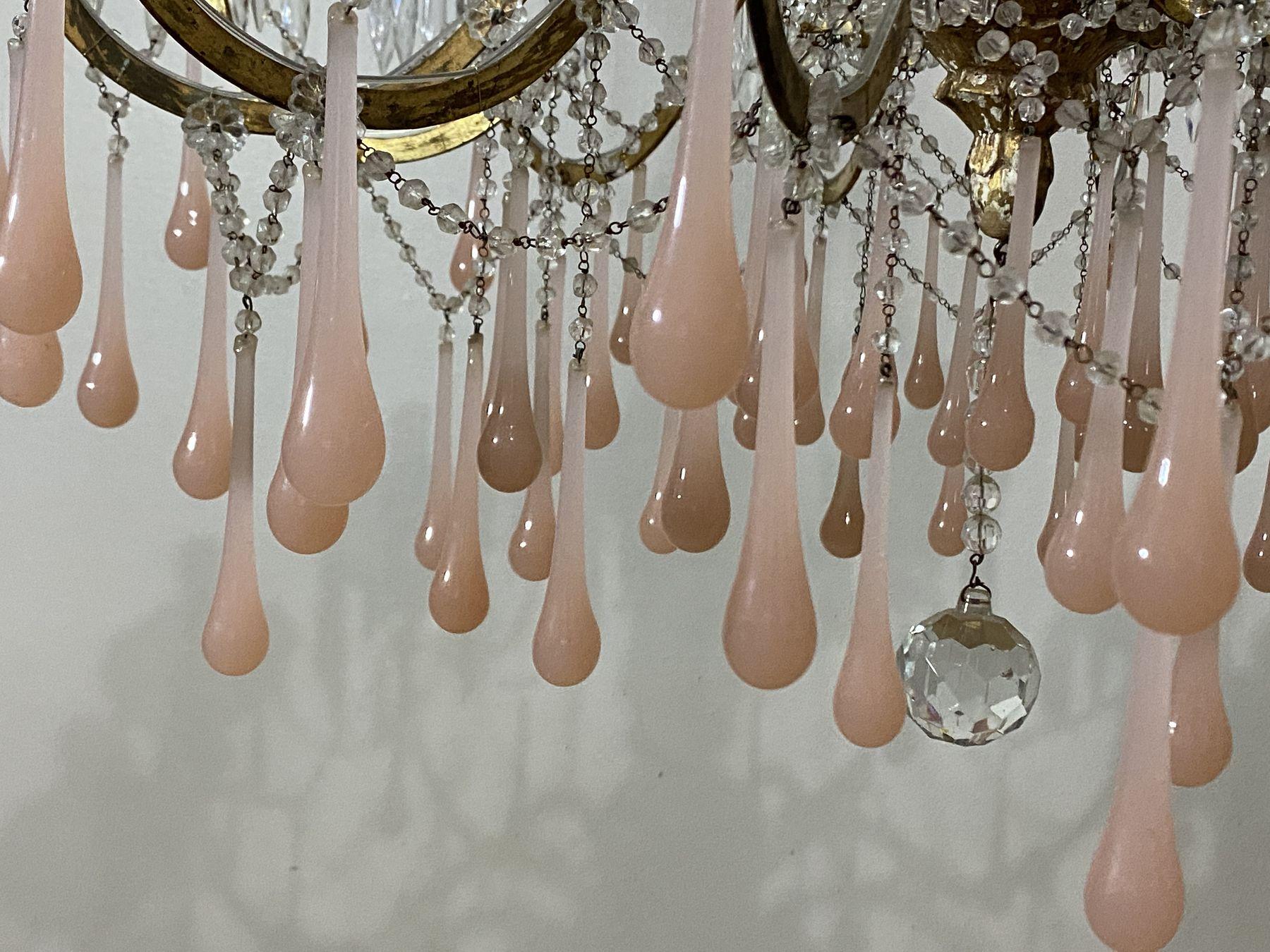 Detail of pink glass drops on a gilt chandelier