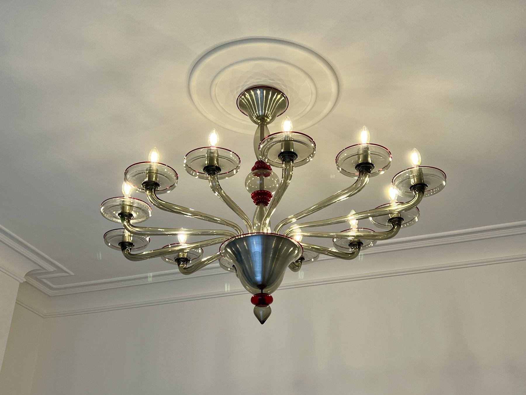 Venetian glass chandelier installed beneath a ceiling rose